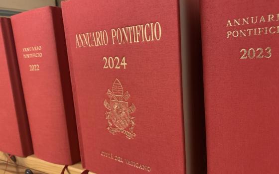 Red and gold front cover of Papal Yearbooks, arranged facing out on shelf